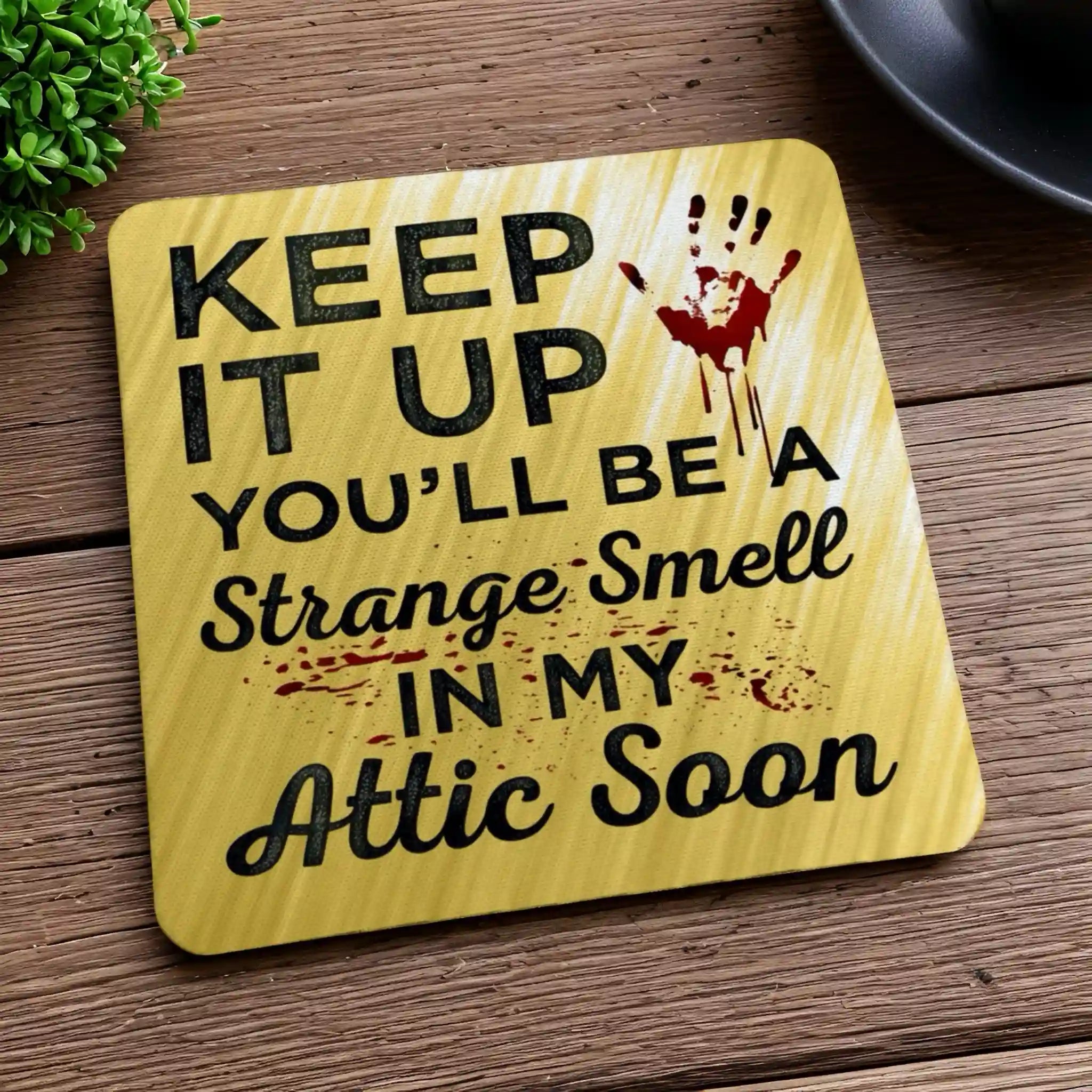 Side view of a set of four 'Strange Smell In My Attic' neoprene coasters with a sarcastic theme, by Laser Design Creations.