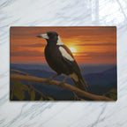 Realistic Australian magpie perched on a branch against a sunset mountain range chopping board from Laser Design Creations