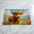 Sweet Highland Cow chopping board by Laser Design Creations, featuring a cute cartoon baby cow sitting in a vibrant meadow of colourful wildflowers