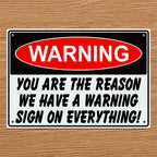 The Reason We Have Warning Signs Novelty Sign Aluminium Sign by Laser Design Creations, featuring the humorous quote "WARNING YOU ARE THE REASON WE HAVE A WARNING SIGN ON EVERYTHING!" in a bold, high-contrast, industrial style.