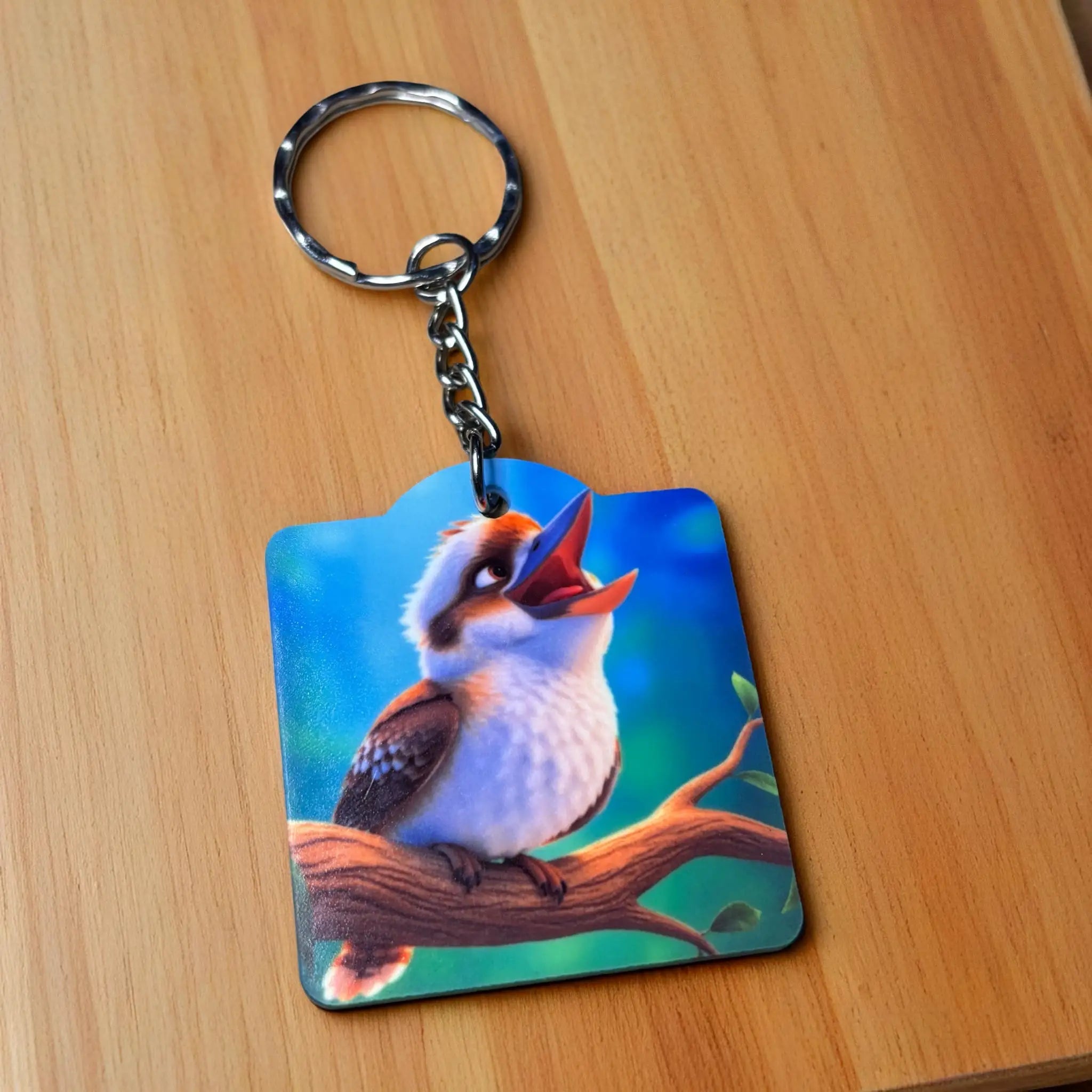 Side view of Vibrant Kookaburra on Branch Acrylic Keyring, showcasing a cheerful cartoon kookaburra laughing on a branch by Laser Design Creations.