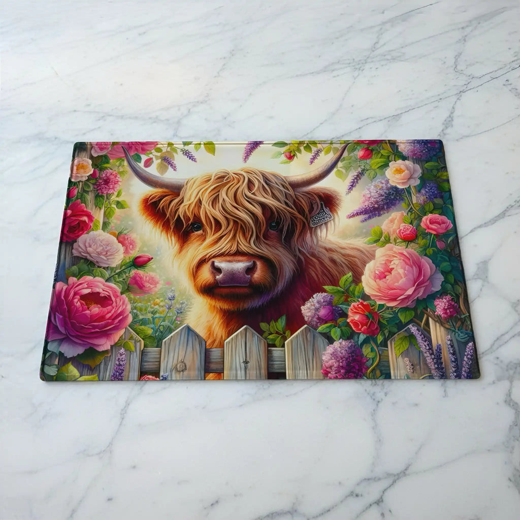 Watercolour Highland Cow Floral Garden glass chopping board by Laser Design Creations, featuring a cute Scottish cow surrounded by pink blooms and green leaves.
