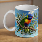Watercolour Rainbow Lorikeet ceramic mug by Laser Design Creations, featuring a colourful Australian lorikeet on a leafy eucalyptus gum branch.