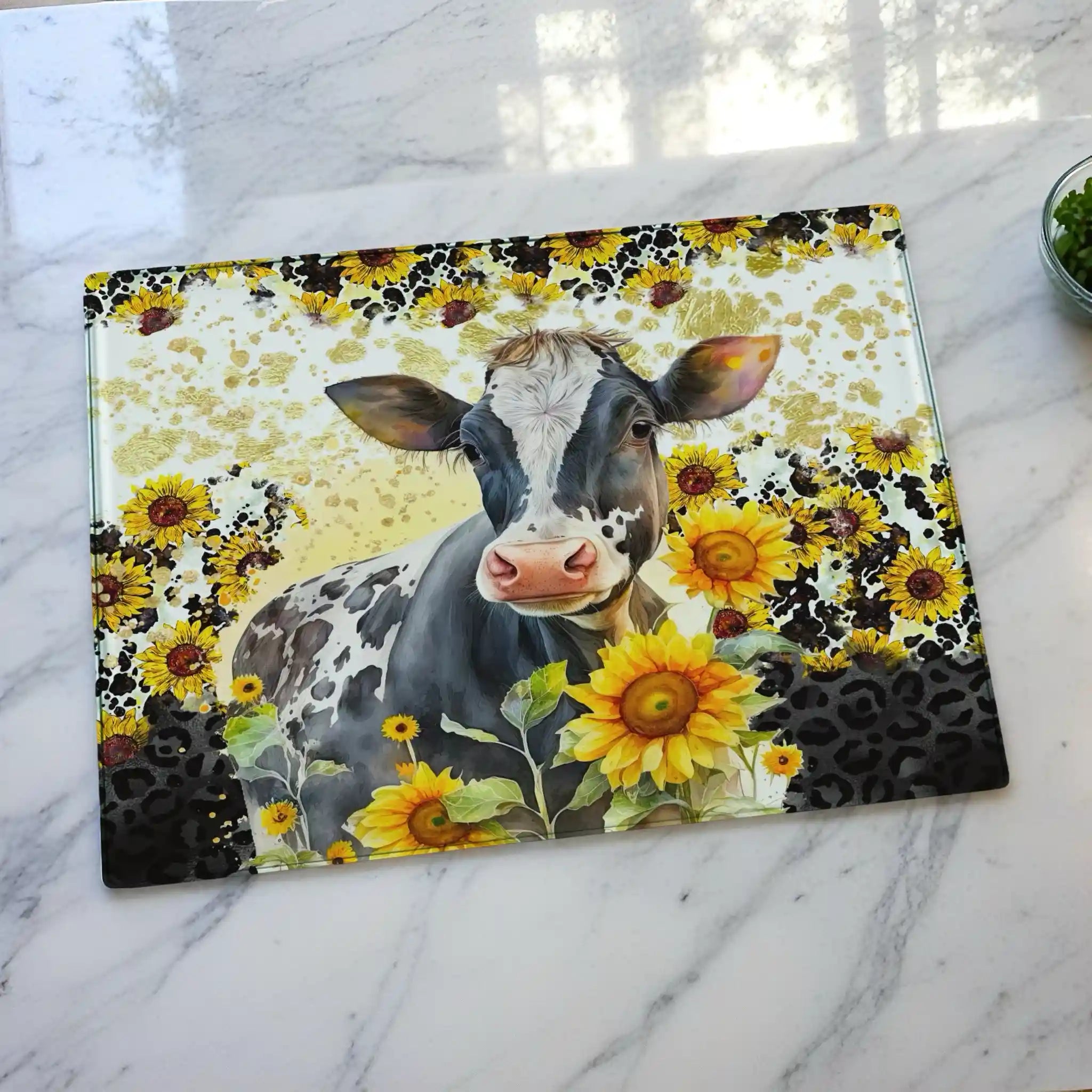 Watercolour Cow & Sunflower chopping board by Laser Design Creations, featuring a charming farmhouse cow surrounded by sunflowers against a bold leopard print background. Displayed on a marble countertop.