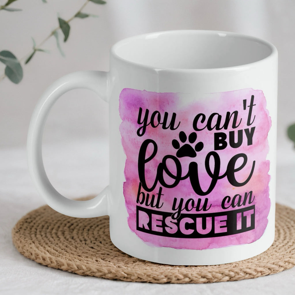 You Can't Buy Love quote ceramic mug by Laser Design Creations, featuring a heartfelt pet rescue message on a pink watercolour background.
