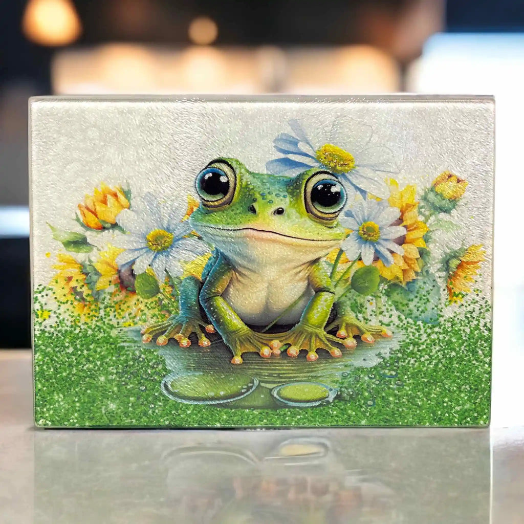 Cute whimsical big eyed frog and daisy detailed botanical art chopping board from Laser Design Creations