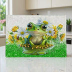 Cute whimsical big eyed frog sitting among daisies and sunflowers glass chopping board from Laser Design Creations