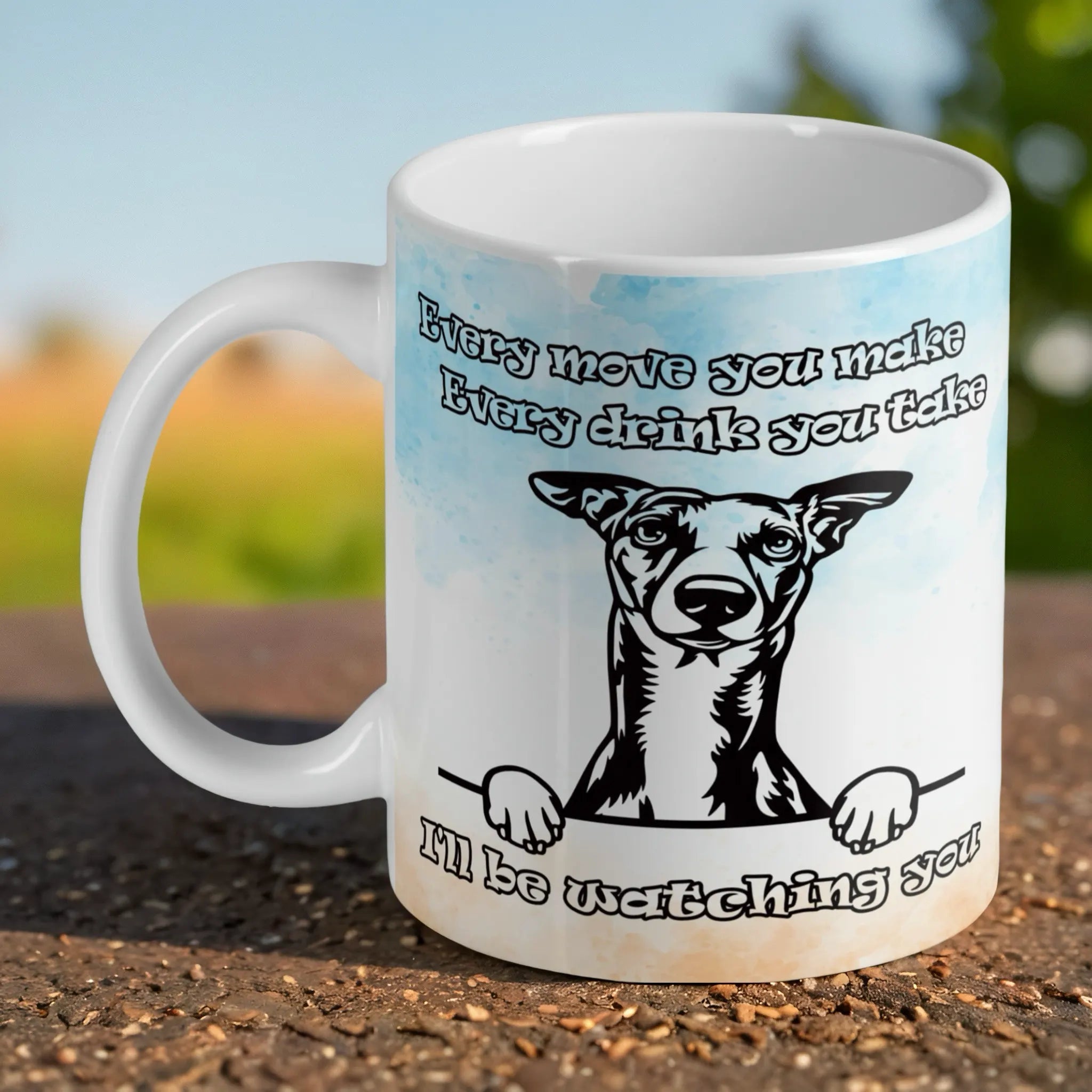 Funny Peeking Whippet Dog ceramic mug by Laser Design Creations, featuring a cheeky black and white illustration of a Whippet with the text 'Every drink you take, I'll be watching you'.