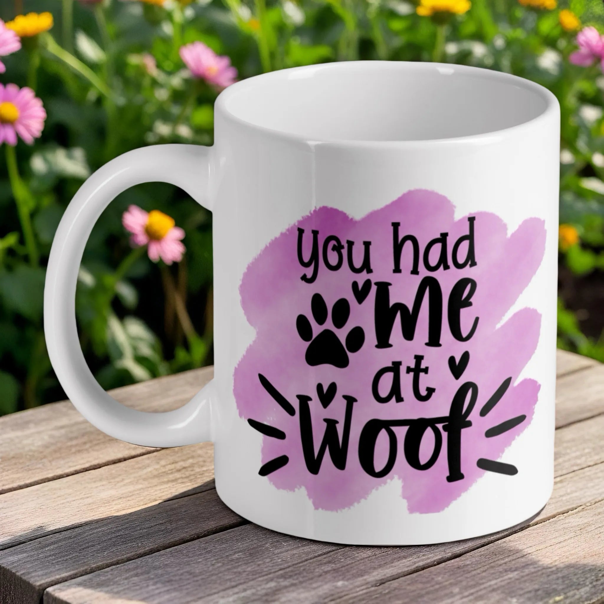 'You Had Me At Woof' ceramic mug by Laser Design Creations, featuring a funny dog quote with a paw print detail against a soft purple watercolour background.