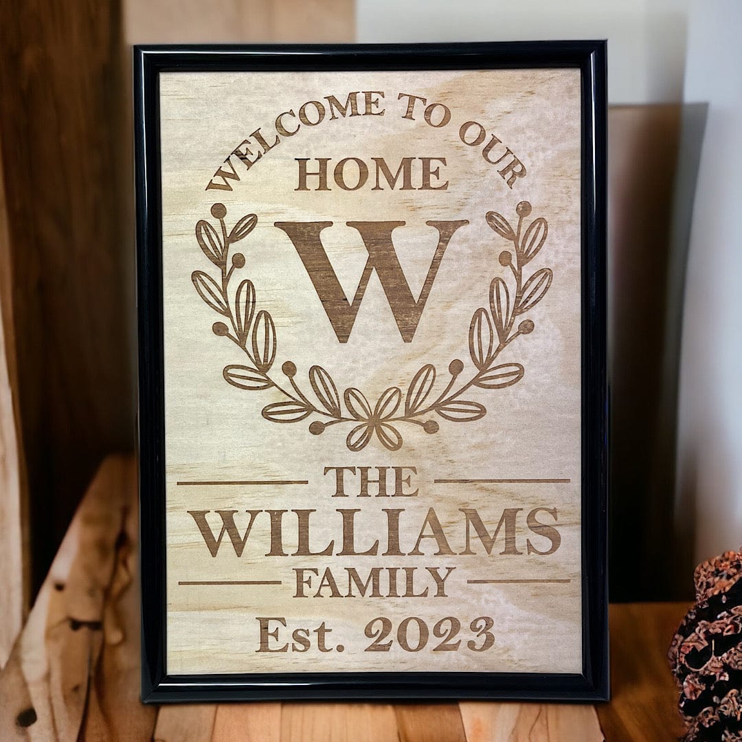 Personalised family welcome wood engraved art with laurel wreath, custom home decor by Laser Design Creations, Australia.